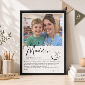 May include: A framed print featuring a photograph of a child and an adult, with the text Maddie, Key Person, noun, and a definition describing a teacher. The design includes a heart graphic with two small handprints and the signature Love Archie G.