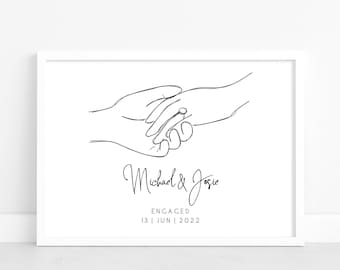 May include: A black and white line drawing of two hands holding each other with a ring on one finger. The text below reads "Michael & Josie Engaged 13 | JUN | 2022".