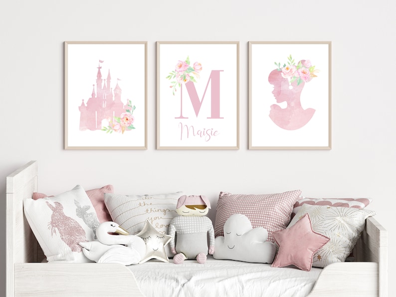 A set of three pink watercolour princess prints. Print 1 is a castle, print 2 is the initial and name, print 3 is a princess head. Available with pink flowers or plain