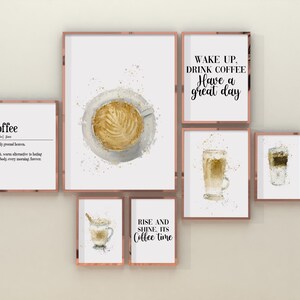 May include: A set of six framed watercolor prints featuring coffee-themed illustrations and quotes. The prints are in a modern style with a white background and gold frames. The quotes include "Coffee", "Wake up, drink coffee, have a great day", "Rise and shine, it's coffee time", and a definition of coffee. The illustrations include a cup of coffee, a glass of latte, and a glass of iced coffee.