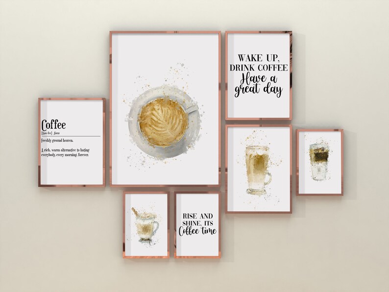 May include: A set of six framed watercolor prints featuring coffee-themed illustrations and quotes. The prints are in a modern style with a white background and gold frames. The quotes include "Coffee", "Wake up, drink coffee, have a great day", "Rise and shine, it's coffee time", and a definition of coffee. The illustrations include a cup of coffee, a glass of latte, and a glass of iced coffee.