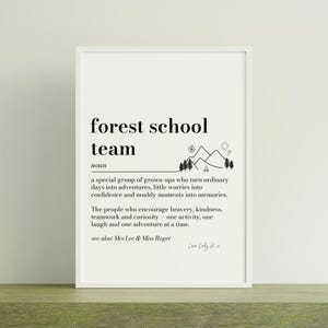 May include: A white framed wall art print featuring black text that defines the term forest school team as a noun. The design includes a line drawing of mountains, trees, and a sun, with the text: a special group of grown-ups who turn ordinary days into adventures, little worries into confidence and muddy moments into memories. The people who encourage bravery, kindness, teamwork and curiosity - one activity, one laugh and one adventure at a time. See also: Mrs Lee & Miss Roger.