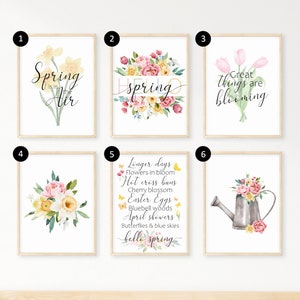 May include: Six printable wall art prints with a spring theme. The prints feature watercolor illustrations of flowers, butterflies, and a watering can. The text on the prints includes "Spring is in the air", "hello spring", "Great things are blooming", and "Longer days, flowers in bloom, hot cross buns, cherry blossom, Easter eggs, bluebell woods, April showers, butterflies & blue skies".