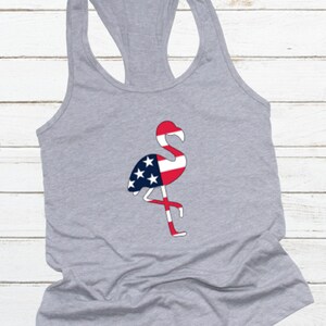 May include: Gray tank top with a flamingo silhouette design. The flamingo is filled with the colors of the American flag.