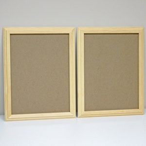 May include: Two natural wood picture frames with a light brown finish. The frames are empty and ready to display photos or artwork.