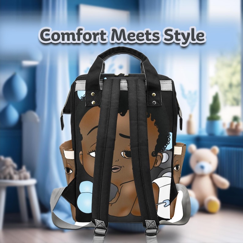 May include: Black diaper bag with a cartoon baby face design. The bag has a top handle, adjustable shoulder straps, and multiple pockets. The text "Comfort Meets Style" is at the top of the bag.