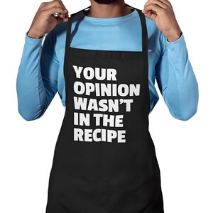 May include: Black apron with white text that reads "Your opinion wasn't in the recipe".