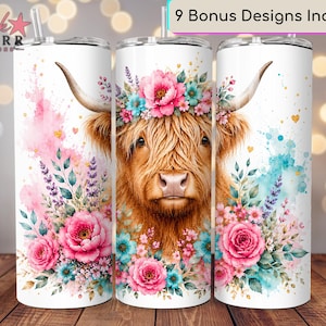 May include: Three cylindrical tumblers with straws featuring a Highland cow illustration. The cow has long brown fur, horns, and a floral crown of pink and teal flowers. Watercolor splashes in pink and blue surround the cow, with small gold hearts.