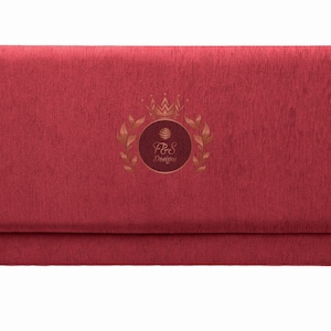 May include: A red velvet envelope with a gold embossed logo featuring a crown, leaves, and the text "F&S Designs".