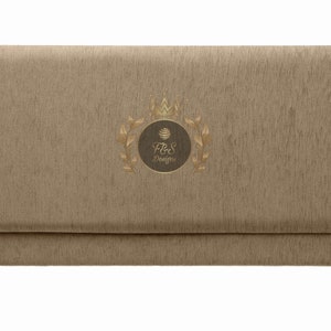 May include: A brown fabric envelope with a gold crown and laurel wreath design. The text "F&S Designs" is inside the wreath.