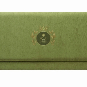 May include: A green fabric envelope with a gold crown and the text "F&S Designs" in a circle.