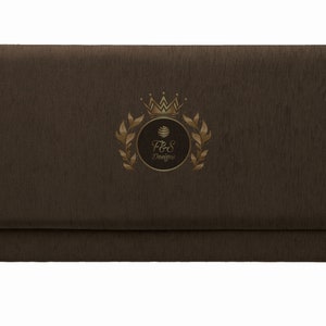 May include: A brown fabric-covered box with a gold logo featuring a crown, a circle with the text "F&S Designs", and a wreath of leaves.