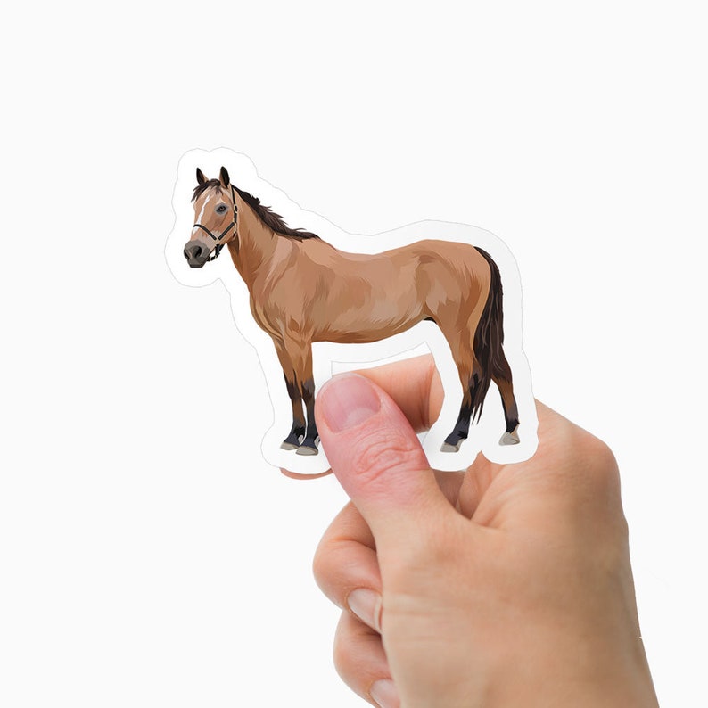 May include: A sticker featuring a tan horse with a dark brown mane and tail. The horse is wearing a bridle. The sticker is held by a hand against a white background. The horse is a sticker.