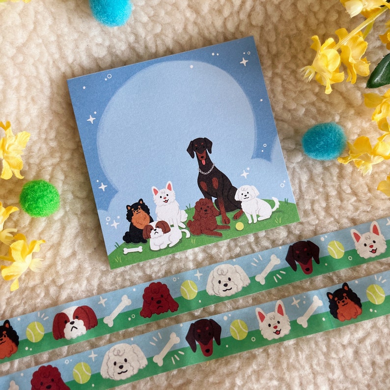 Puede incluir: Una tarjeta azul y blanca con una ilustraci&oacute;n de dibujos animados de seis perros. Los perros son un perro negro y marr&oacute;n, un perro blanco, un perro marr&oacute;n, un perro negro, un perro blanco y un perro blanco. La tarjeta est&aacute; sobre una superficie blanca y peluda.
