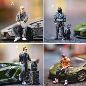 May include: Four miniature figurines: A shows a person in a gray jacket and pants sitting on a car; B shows a person in a black hooded outfit with a dog; C shows a person in a black shirt with a suitcase; D shows a shirtless person with a bandana.