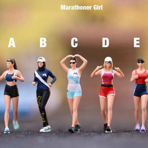 May include: Miniature figurines of marathon runners in various outfits. The figures are labeled A through E. The outfits include sports bras, shorts, and running gear in colors like blue, red, and white. The text "Marathoner Girl" is at the top.