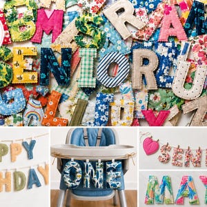 May include: A collection of fabric letters featuring various floral, striped, and patterned prints with scalloped edges. The display includes examples of these letters arranged as banners spelling Happy Birthday, One, Senior, and the name Maya.