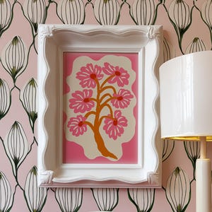 Flat-graphic illustration of a stylized orange tree trunk sprouting bright pink daisies on a cream blob shape against a vibrant pink background—cheerful, preppy and coquette-inspired.