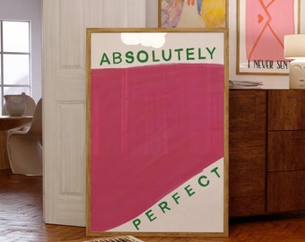 Peut inclure: Une affiche encadrée rose et blanche avec le texte "ABSOLUTELY PERFECT" en lettres vertes. L'affiche est accrochée à un mur avec d'autres affiches encadrées.