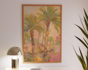 May include: A framed painting of a tropical landscape with palm trees and a pink and orange sunset. The painting is hanging on a white wall above a light brown cabinet with a white lamp on top.