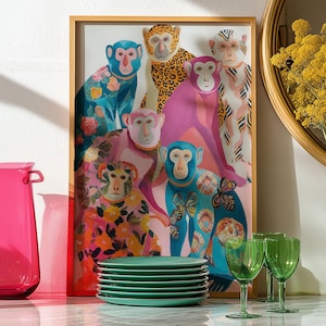 May include: A vibrant art print of several monkeys with floral and leopard patterns. A stack of green plates, green wine glasses, and a pink jug are in front of the artwork. A round mirror and a vase with yellow flowers are also visible.