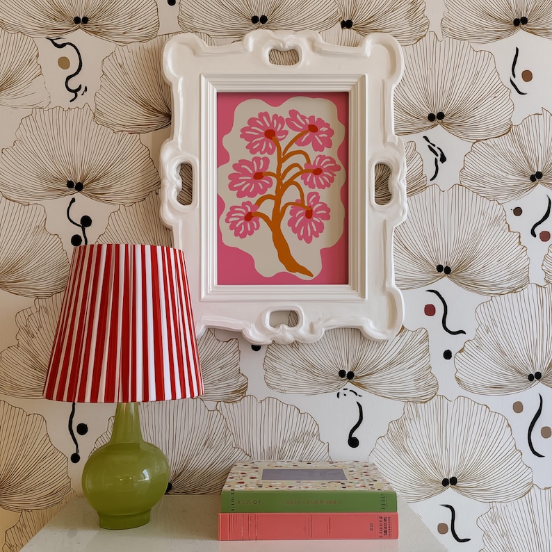 Flat-graphic illustration of a stylized orange tree trunk sprouting bright pink daisies on a cream blob shape against a vibrant pink background—cheerful, preppy and coquette-inspired.