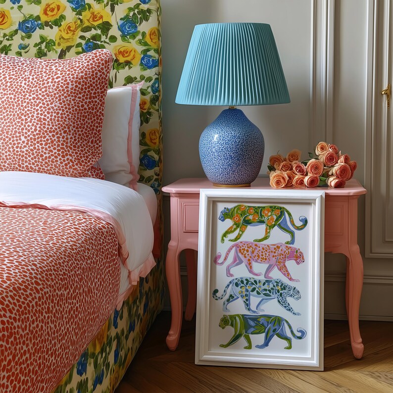 Four prowling leopards in vivid green, pink, sky-blue and indigo coats, each with whimsical floral patterns, stride across a cream backdrop. The bold dopamine palette enlivens living rooms, nurseries or eclectic gallery walls.