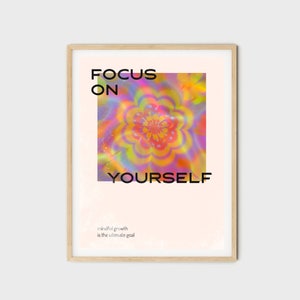 May include: A motivational poster featuring a colourful abstract flower design and the text "FOCUS ON YOURSELF" in black. The text "mindful growth is the ultimate goal" is printed in a smaller font below the main text.