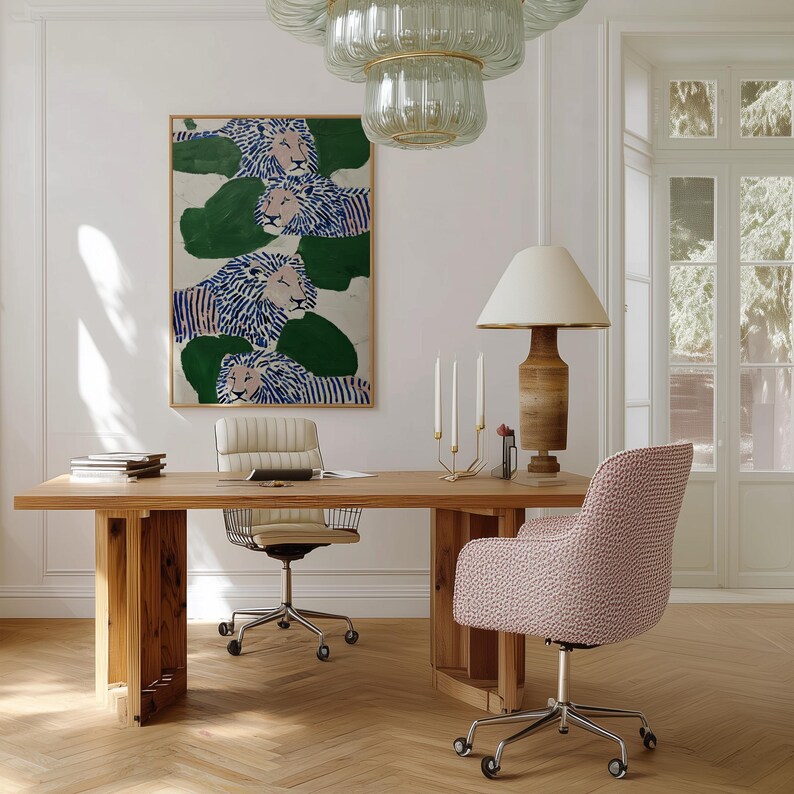 May include: A light wood desk with a cream-colored office chair and a pink patterned chair. A large framed painting of lions hangs on the wall. A wooden lamp with a cream shade and a glass chandelier are also visible.
