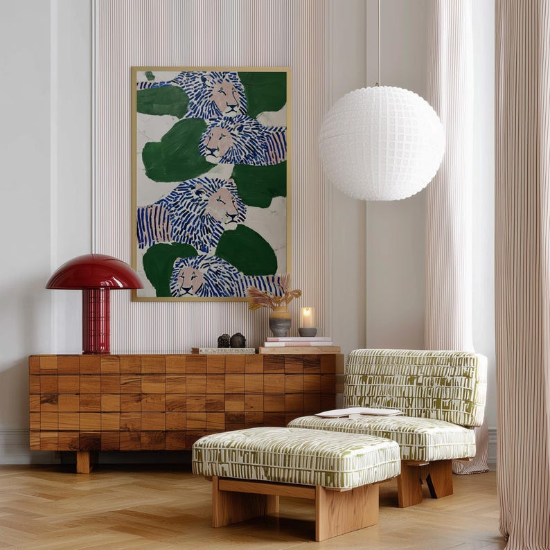 May include: A living room scene featuring a wooden cabinet, a green and white patterned chair and ottoman, and a large framed artwork with lion illustrations. A red mushroom-shaped lamp and a white globe pendant light add to the decor.