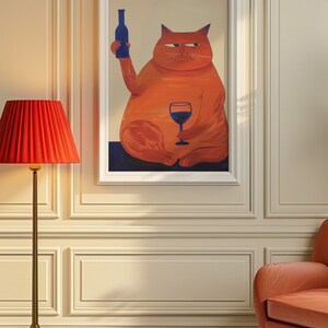 May include: A framed illustration of an orange cat holding a glass of red wine and a bottle of wine. The cat is sitting on a blue background.