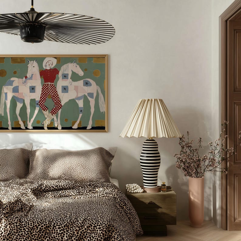 Modern western art print featuring a stylish cowgirl in a white hat and red polka dot outfit posed between two white patchwork horses. Soft sage green background with gold geometric accents and quilt-like horse patterns create a chic, editorial equestrian vibe. Perfect for contemporary western decor, ranch house interiors, cowgirl chic bedrooms, offices, and giftable horse lover wall art.