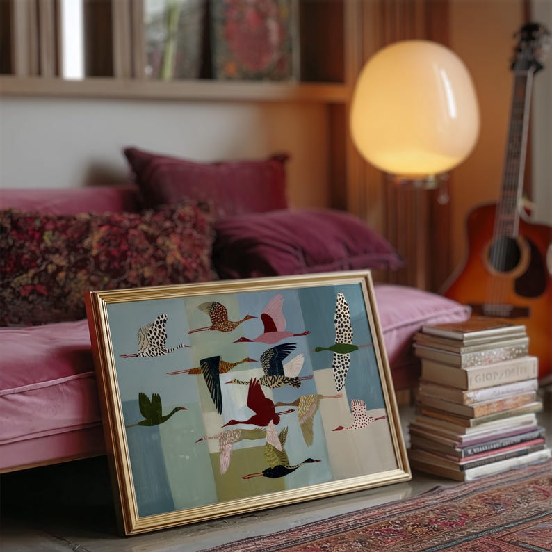 May include: A rectangular framed wall art piece featuring a stylized illustration of multiple birds in flight against a segmented blue and green background. The birds are depicted in various colors including red, black, white, and gold with spotted patterns.