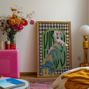 Virgo zodiac wall art featuring a dazzling, vintage-style showgirl held gracefully by a green hand, adorned in vibrant bejeweled fashion. Surrounded by bold “Virgo” lettering and a retro pink-and-green checkerboard frame, this mystical, feminine artwork is perfect for astrology lovers, coquette dorms, and magical bedroom spaces.