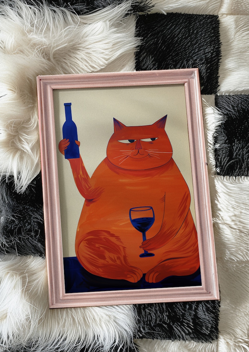 May include: A framed illustration of an orange cat holding a glass of red wine and a blue bottle of wine. The cat has a sly expression on its face.