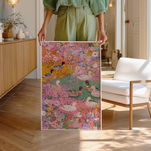 May include: A framed art print depicting a colourful floral scene with ducks. The artwork features a vibrant mix of pink, yellow, and green flowers, with several ducks dotted throughout. The ducks have white, brown, and black feathers.