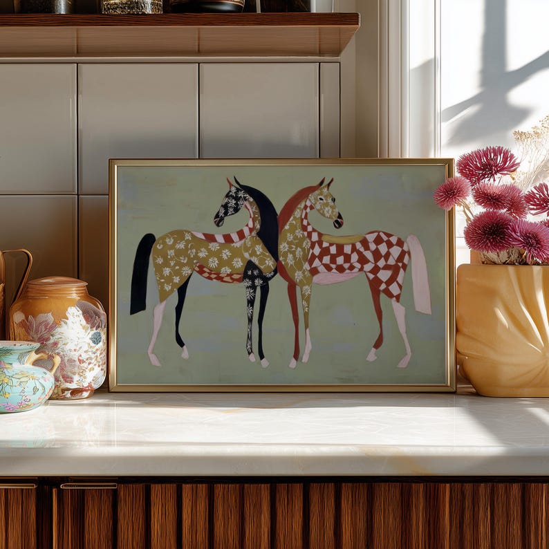 May include: A framed art print featuring two stylized horses. One horse has a black body with a white and black floral pattern, and the other has a red and white checkered pattern. The background is a light green color.