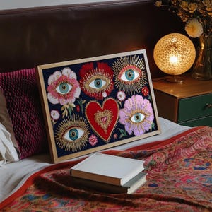 Mystical wall art featuring all-seeing eyes set in radiant flowers with golden rays, anchored by a glowing red heart. This visionary artwork merges mysticism, folk spirituality, and psychedelic symbolism, making it a perfect fit for a witchy boho room, meditation corner, or spiritual gift. Designed for lovers of esoteric beauty and third-eye awakening art.