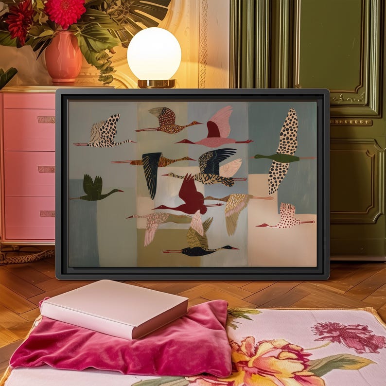 May include: A rectangular framed wall art piece featuring a stylized illustration of a flock of birds in flight. The birds are depicted in various colors including red, black, white, and green, set against a background of muted geometric color blocks.