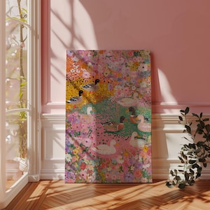May include: A canvas print with a floral and duck design. The artwork features a vibrant mix of pink, yellow, and green hues, with detailed depictions of ducks amidst the flowers. The artwork is displayed in a room with a window and wooden flooring.