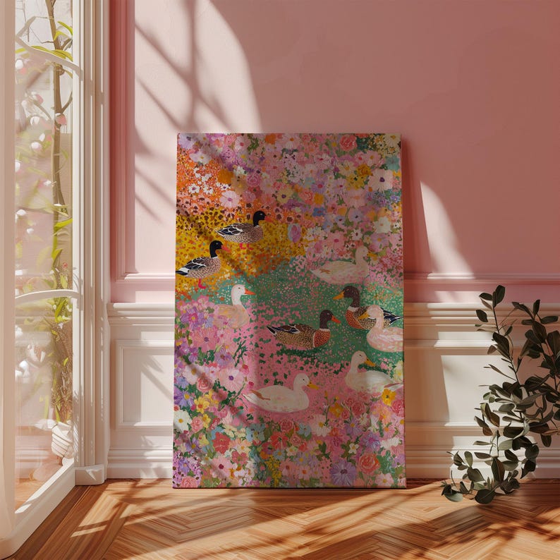 May include: A canvas print with a floral and duck design. The artwork features a vibrant mix of pink, yellow, and green hues, with detailed depictions of ducks amidst the flowers. The artwork is displayed in a room with a window and wooden flooring.