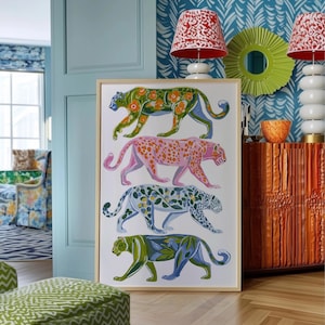 Four prowling leopards in vivid green, pink, sky-blue and indigo coats, each with whimsical floral patterns, stride across a cream backdrop. The bold dopamine palette enlivens living rooms, nurseries or eclectic gallery walls.