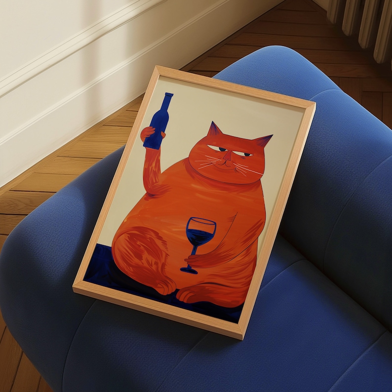 May include: A framed illustration of an orange cat holding a glass of red wine and a blue bottle. The cat is wearing a sly expression and has a white background.
