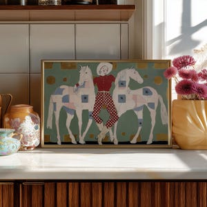 Modern western art print featuring a stylish cowgirl in a white hat and red polka dot outfit posed between two white patchwork horses. Soft sage green background with gold geometric accents and quilt-like horse patterns create a chic, editorial equestrian vibe. Perfect for contemporary western decor, ranch house interiors, cowgirl chic bedrooms, offices, and giftable horse lover wall art.