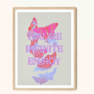 May include: A framed print with a pink and white butterfly design. The text "YOU ARE INFINITE ENERGY" is written in pink letters on a light gray background.