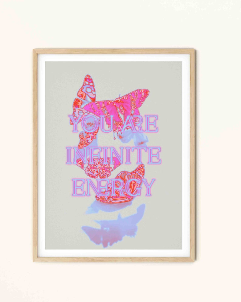 May include: A framed print with a pink and white butterfly design. The text "YOU ARE INFINITE ENERGY" is written in pink letters on a light gray background.