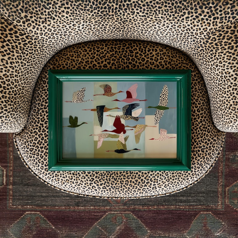 May include: A rectangular wall art piece featuring a collection of stylized birds in flight, rendered in various colors and patterns, enclosed within a glossy, deep green frame. The artwork displays multiple avian figures against a segmented background.