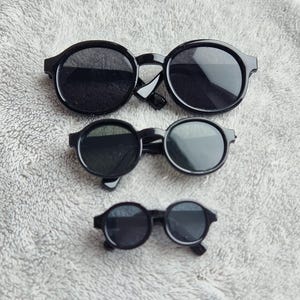 Black Rimmed with Black Lenses Plastic Doll Glasses Sun Glasses - various sizes approx 9cm/90mm wide, 6.5cm/65mm, 4.5 cm/45mm wide