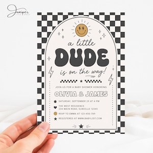 May include: A rectangular baby shower invitation card featuring a black and white checkered border and an arched center panel. The text reads A little DUDE is on the way! Join us for a baby shower honoring Olivia & James, Saturday, September 29 at 4 PM, The West Residence, 234 Main Road, Sunville 12345, RSVP to Emma at 123-456-789, Registered at www.babylist.com.