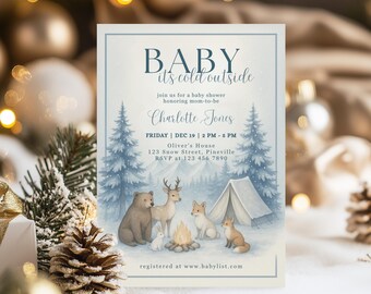 May include: A baby shower invitation with a winter theme. The text "BABY it's cold outside" is at the top. The invitation includes the name "Charlotte Jones", date, time, and location. Illustrations of forest animals and a campfire are featured.